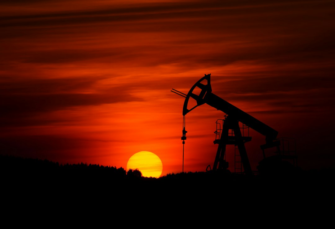 Oil pumpjack at sunset illustrating oil and gas jobs